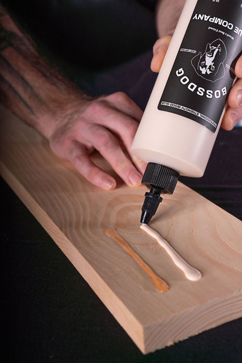 BOSSDOG wood glue being spread on plank of wood